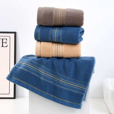 Une serviette en soie dorée sombre, douce et absorbante, idéale pour la maison.